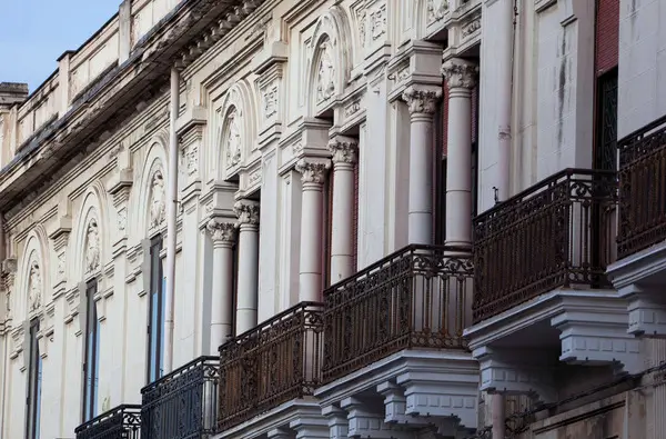 Historic building façade with Corinthian columns and wrought iron balconies along Corso Garibaldi Reggio Calabria.