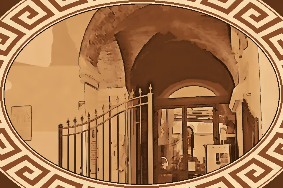 Main entrance of the Diocesan Museum of Reggio Calabria inside the Archbishop’s Palace, featuring historic arches and sacred architectural details.