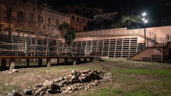 Griso-Laboccetta archaeological area in Reggio Calabria, showing ancient temple ruins surrounded by modern urban streets.