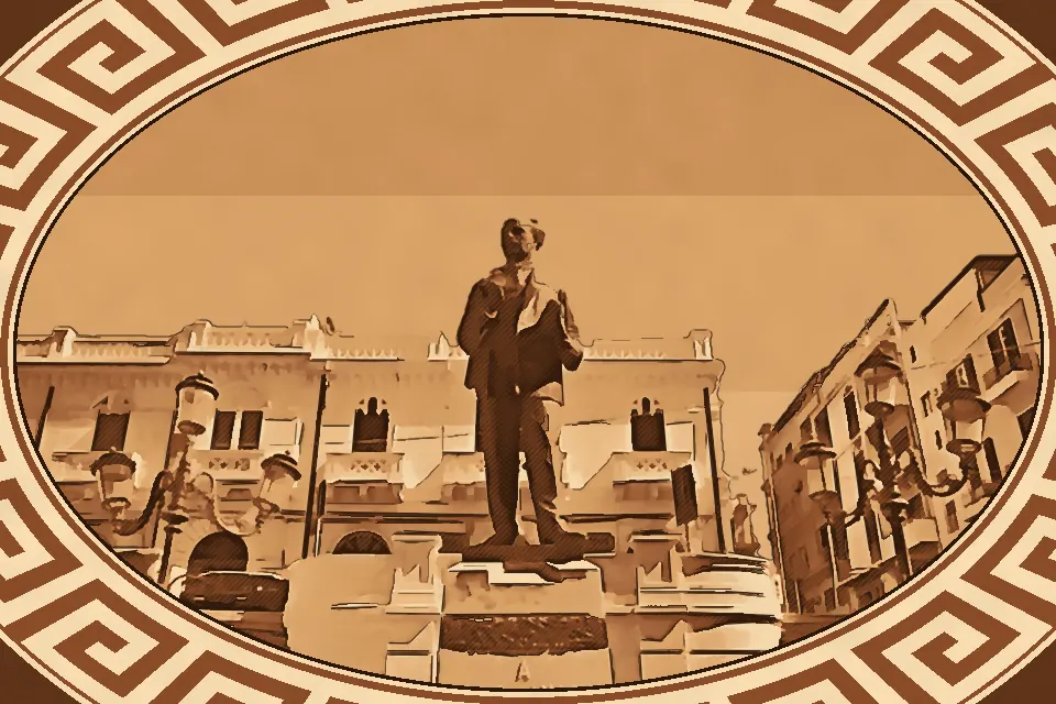 Bronze statue of Biagio Camagna in Piazza Camagna, Reggio Calabria, highlighting the sculpted figure and its Liberty-style architectural backdrop.