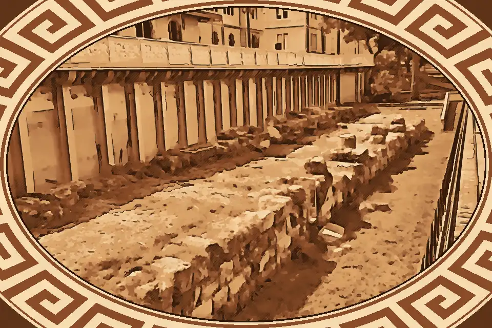 Greek Walls Reggio Calabria along Lungomare Falcomatà, showing preserved sandstone blocks and wrought iron fence near Piazza Camagna.