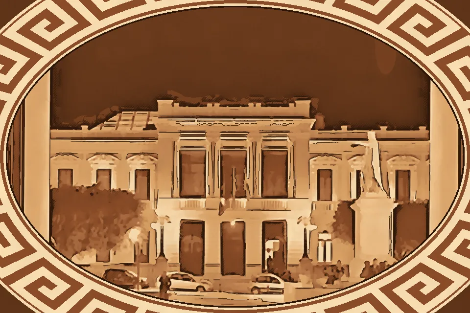 Elegant view of Palazzo Corrado Alvaro in Reggio Calabria, featuring a Roman altar and historic sculptures inside the grand staircase.