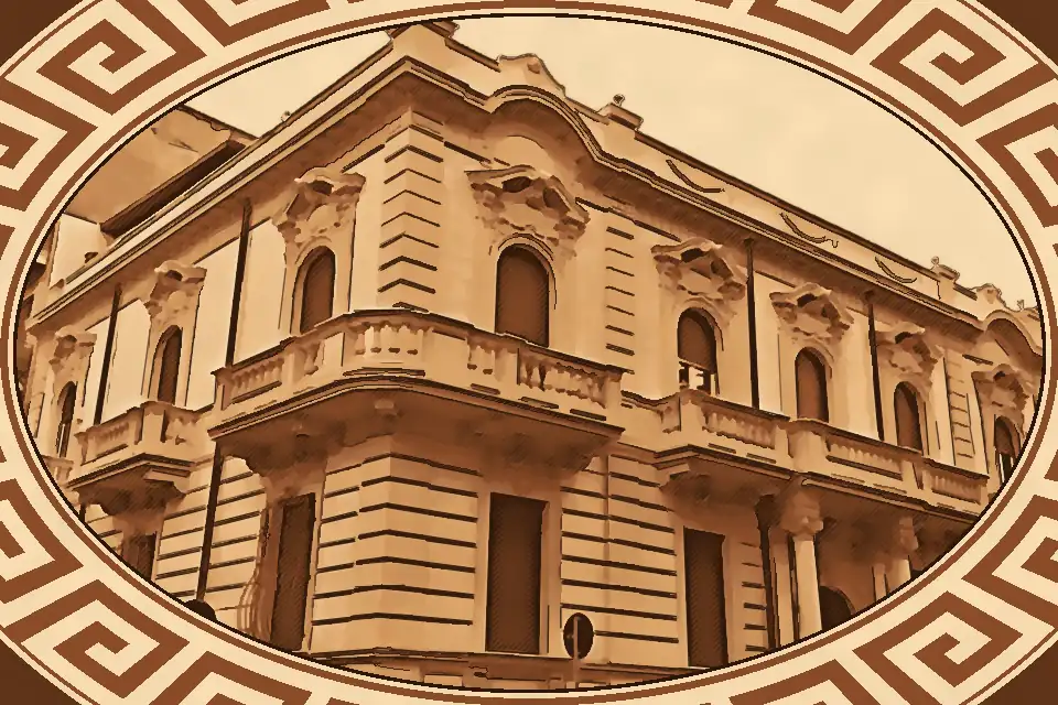 Palazzo Guarna Reggio Calabria façade with Liberty-style floral decorations, neoclassical columns, and ornate balconies in the historic city center.