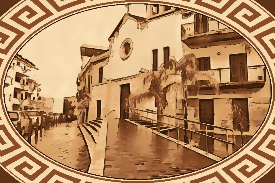 St. Anna Church in Reggio Calabria with wet streets, classical architecture, and urban reflections on a cloudy day.