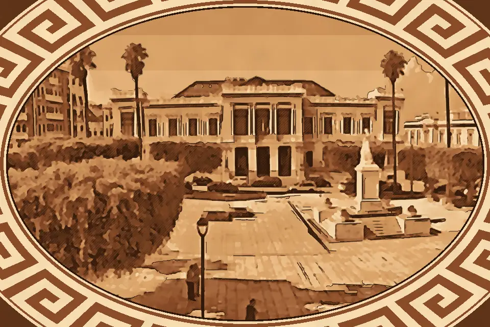 Panoramic view of Piazza Italia in Reggio Calabria, featuring the central Italia Turrita monument, neoclassical public buildings, trimmed trees, and a bright blue sky.