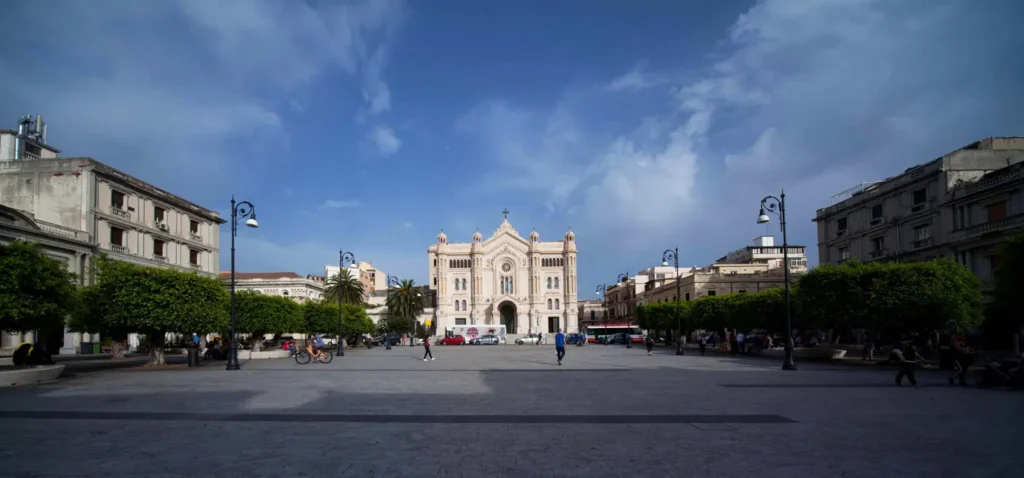 A panoramic view of Piazza Duomo Reggio Calabria with the Cathedral and surrounding historic buildings.