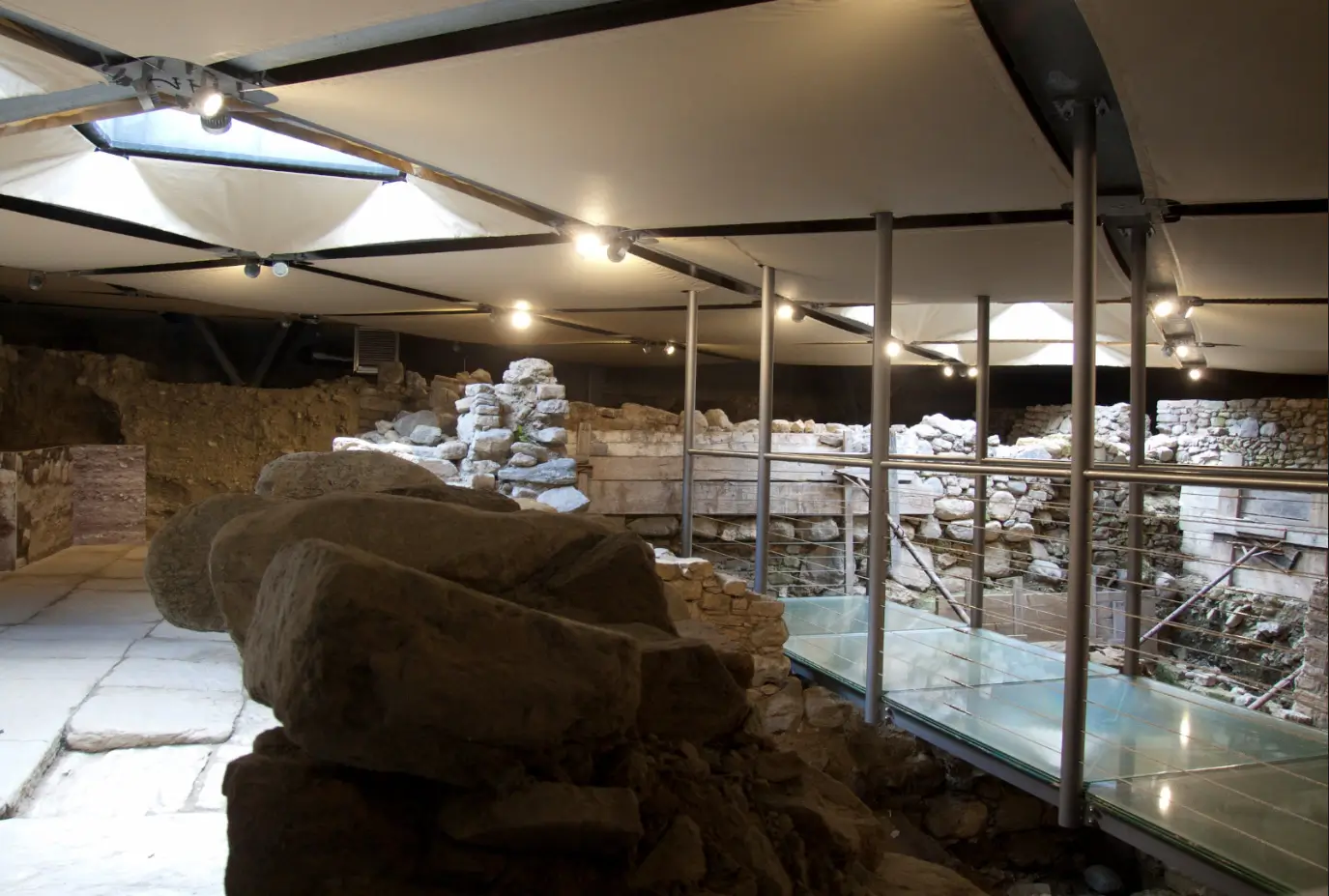Interior of the Hypogeum of Piazza Italia showing ancient walls and archaeological layers
