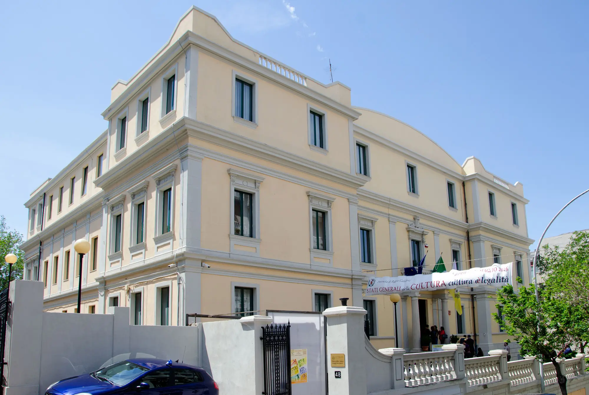 Exhibition hall of Palazzo Crupi with paintings, ancient books, and sacred art objects on display.