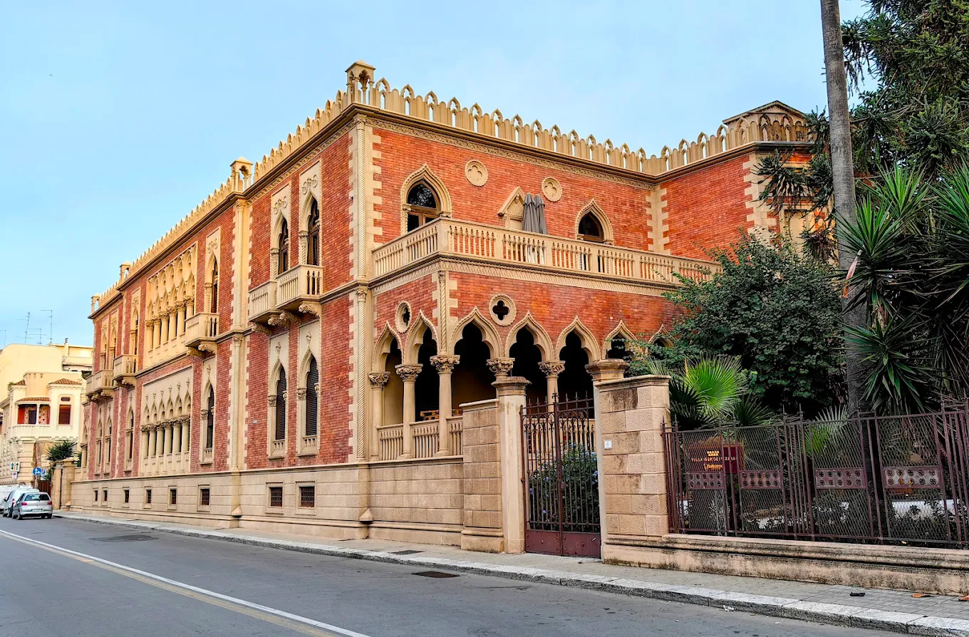 Villa Genoese Zerbi: a Gothic-style villa with battlements, arches, and rich architectural details in Reggio Calabria.