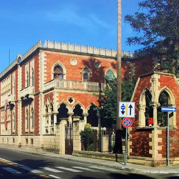 Villa Genoese Zerbi: a Gothic-style villa with battlements, arches, and rich architectural details in Reggio Calabria.