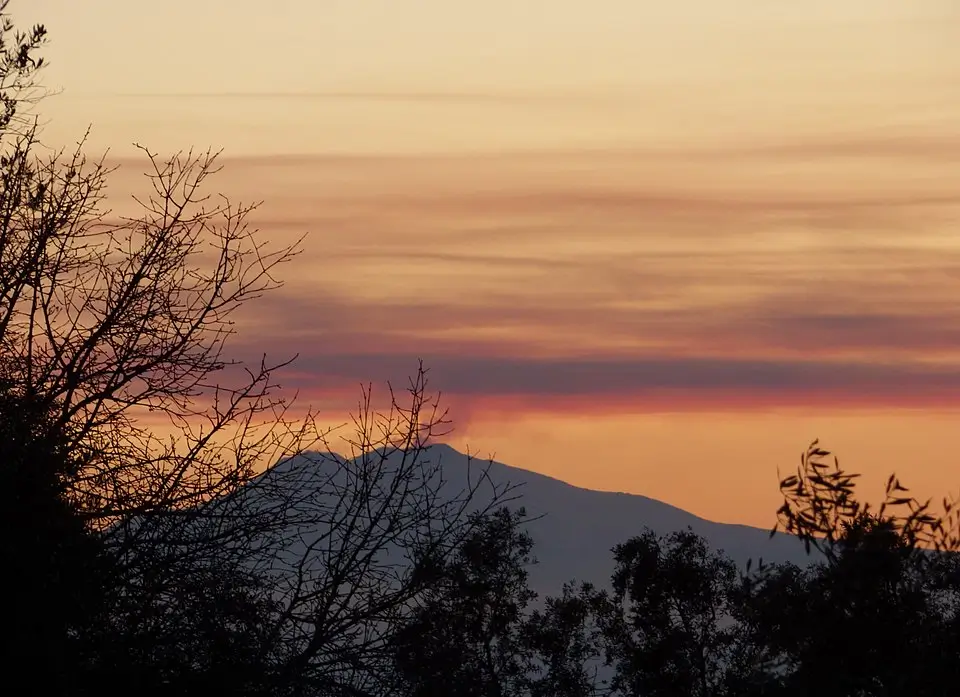Panoramic view from Ortì over the Strait of Messina, with the distant silhouette of Mount Etna on Sicily.