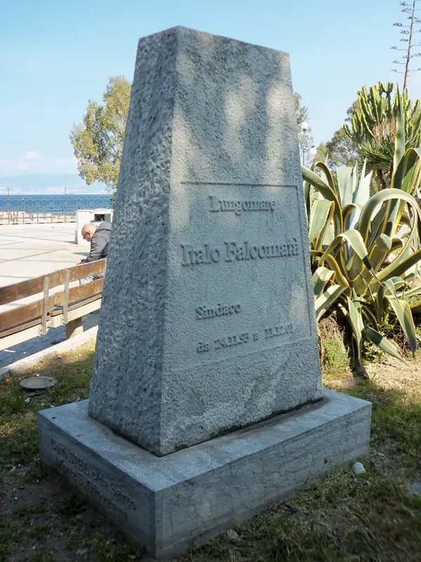The Stele to Italo Falcomatà overlooking the Falcomatà Promenade, surrounded by palms and the seafront landscape.